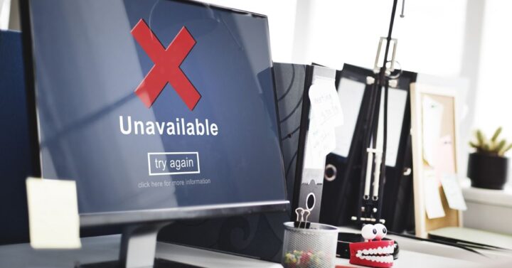 Home office computer monitor displaying an unavailable connection error with a red X.
