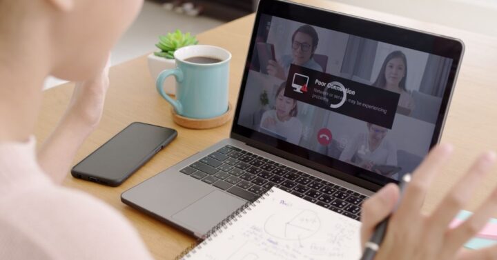 Home office worker experiencing a poor internet connection during a video conference on a laptop.